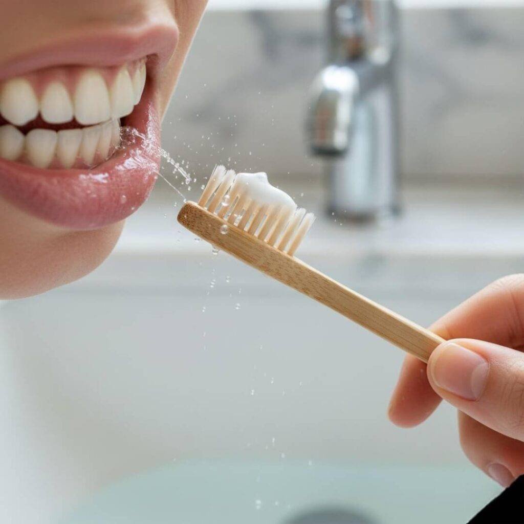 Close-up of bamboo toothbrush mid-brush.