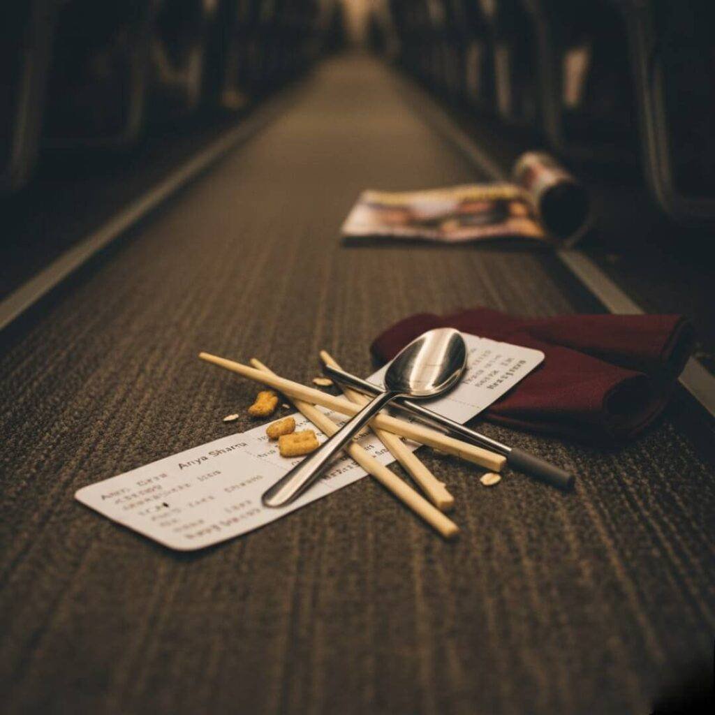 Tangled reusables, boarding pass, and snack crumbs.